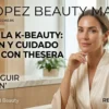 Portada de revista digital de belleza con una mujer elegante en bata blanca y productos de cosmética coreana THESERA
